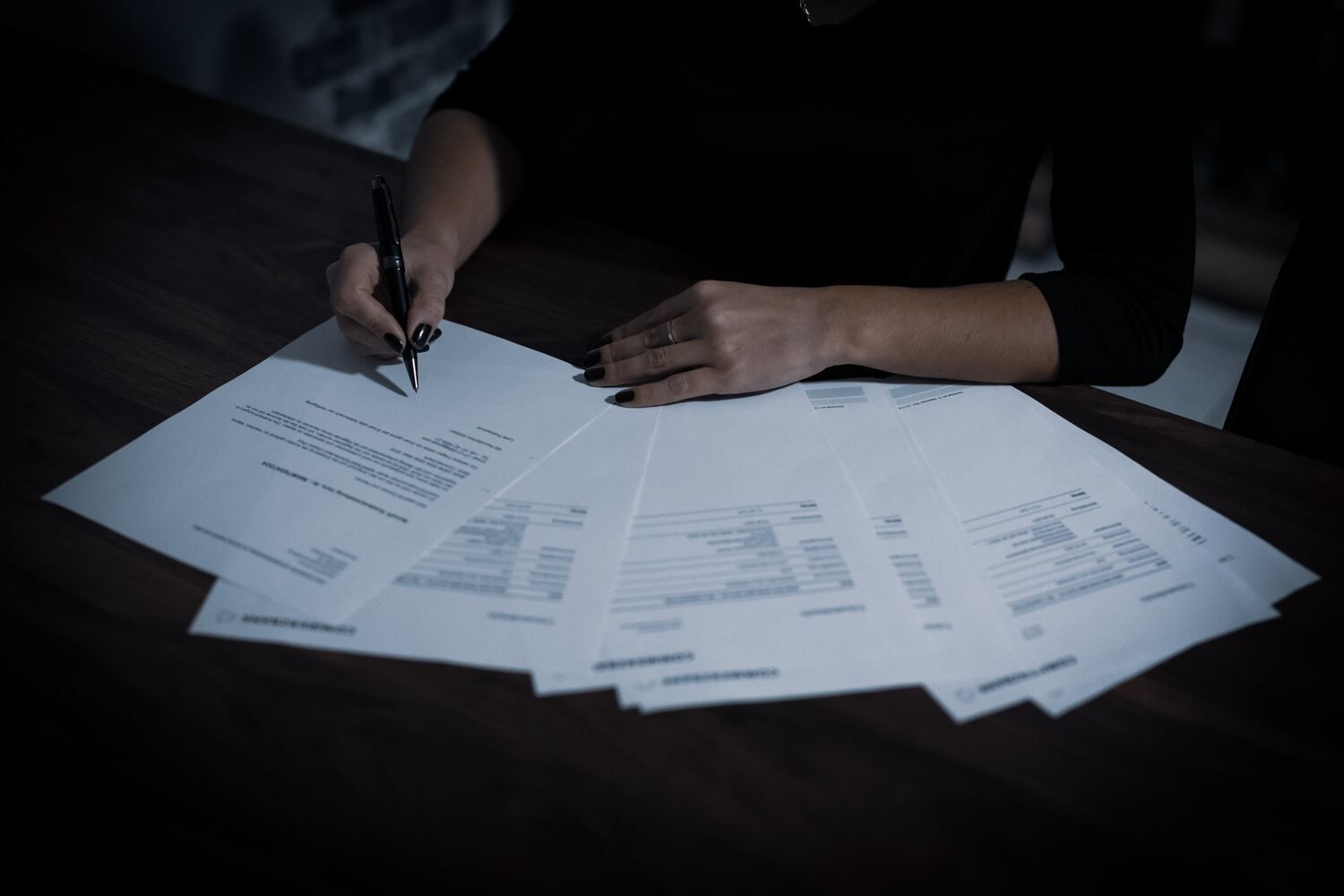 A stack of document fanned out on a desk